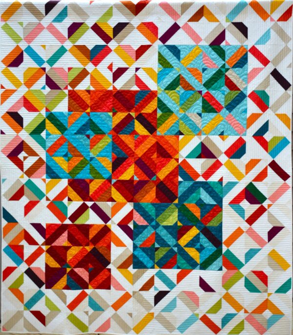 A colorful, geometric quilt—perfect for a quilt show in Marietta GA—features overlapping squares and diamond patterns in vibrant reds, blues, greens, and yellows on a white background with scattered, multicolored diagonal lines.