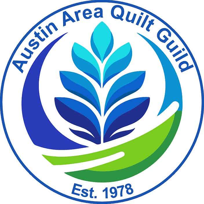 Austin Area Quilt Guild logo with blue text, a stylized quilted leaf in blues and green accents. The text reads Austin Area Quilt Guild around the top and Est. 1978 at the bottom, representing Quiltfest in Austin TX.