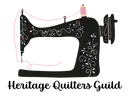 Heritage-Quilters-Guild Illustration of a vintage sewing machine decorated with pink accents and white floral designs, with a spool of thread on top.